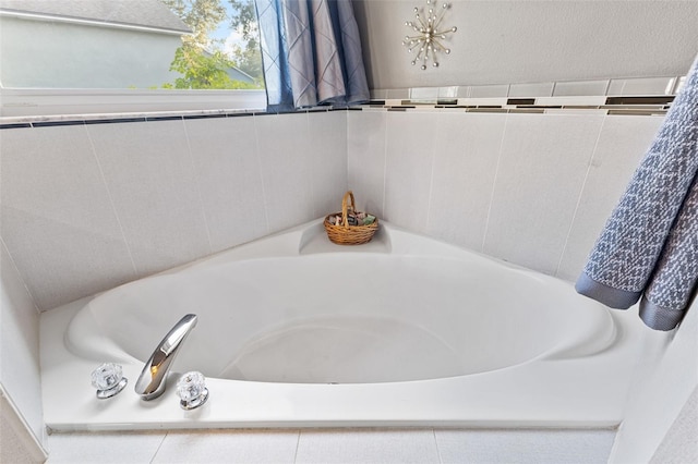 bathroom featuring tiled tub