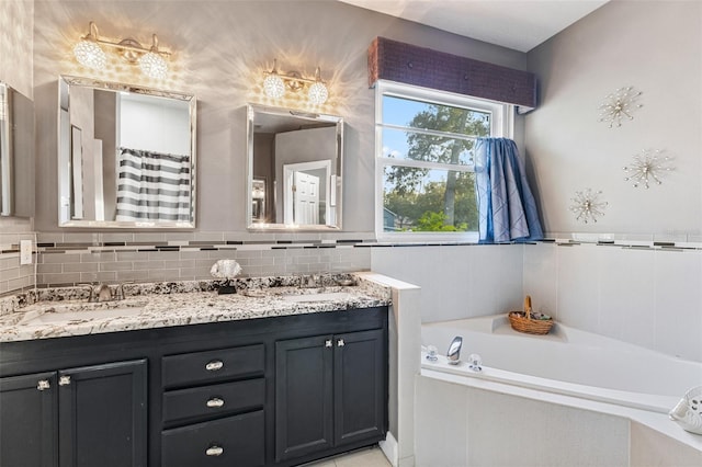 bathroom with vanity and a washtub