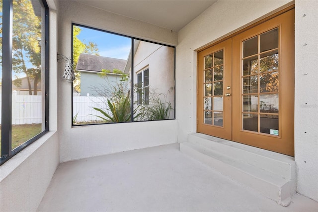 unfurnished sunroom with french doors