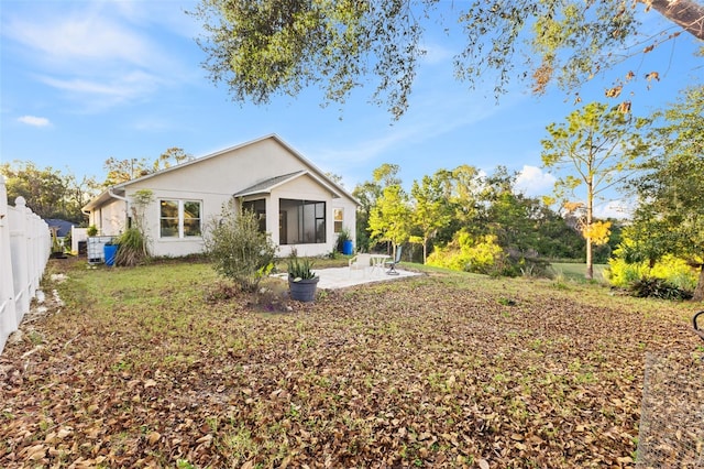 back of property with a patio