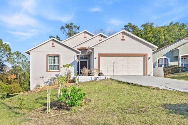 view of front of property with stucco siding, a front lawn, a garage, and driveway