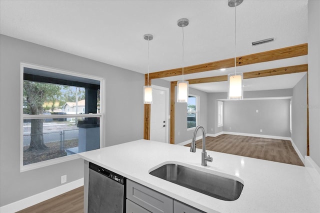 kitchen with gray cabinets, sink, decorative light fixtures, dishwasher, and beamed ceiling