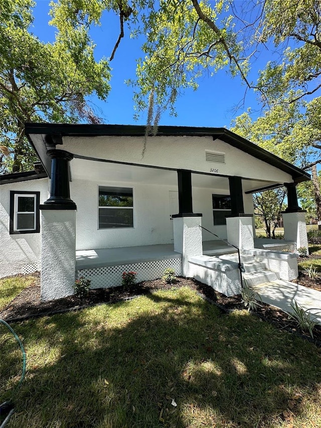 3206 N 29th St, Tampa, FL 33605 - rear view of house featuring a yard, covered porch, and stucco siding