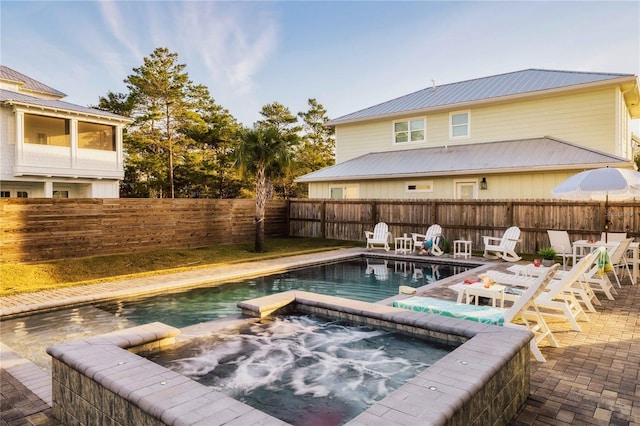 view of pool with an in ground hot tub and a patio area