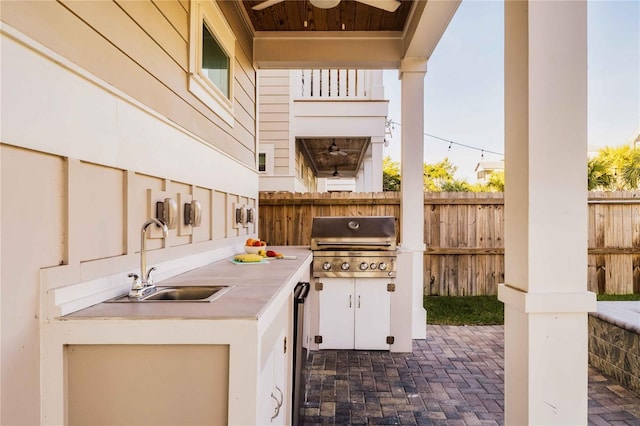 view of patio / terrace with ceiling fan, area for grilling, and sink