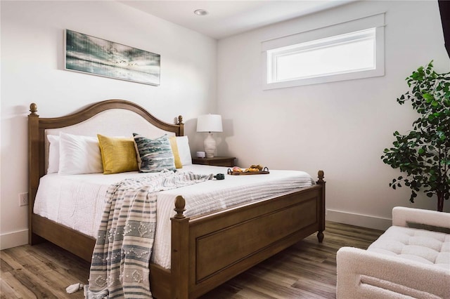 bedroom with hardwood / wood-style flooring