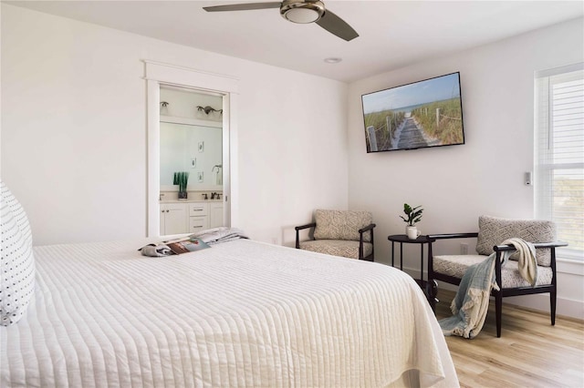 bedroom featuring connected bathroom, ceiling fan, and light wood-type flooring