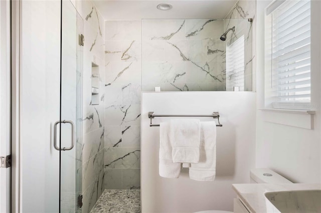 bathroom featuring an enclosed shower, vanity, and toilet