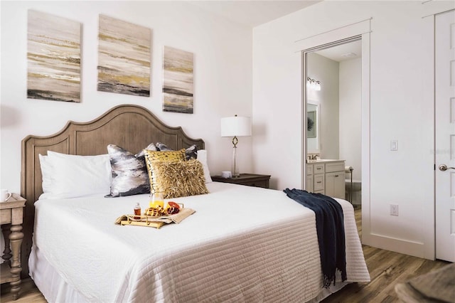 bedroom featuring wood-type flooring and ensuite bathroom