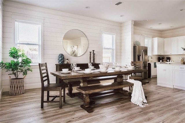 dining space with light hardwood / wood-style flooring