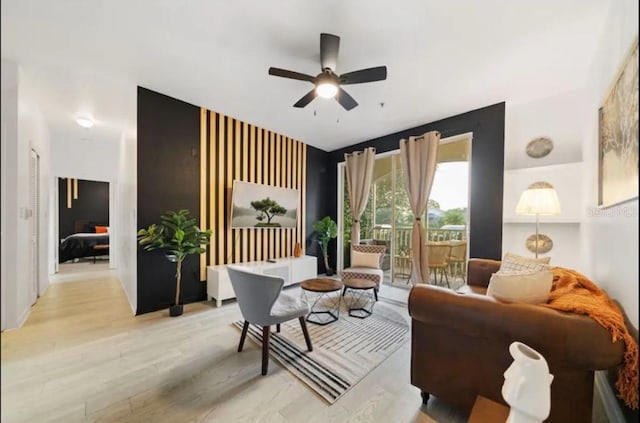 sitting room with ceiling fan and light hardwood / wood-style floors