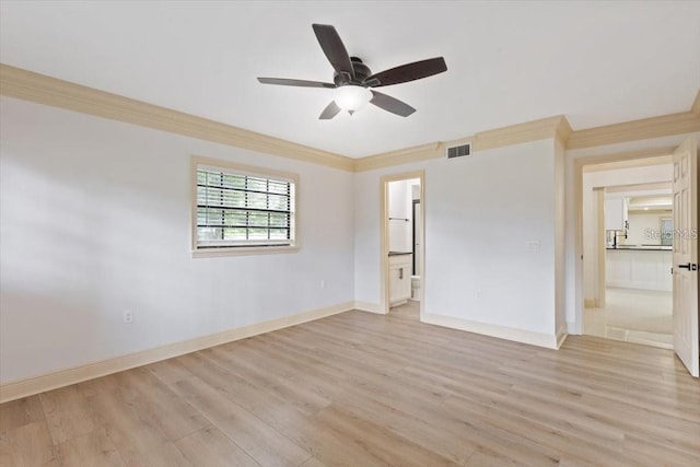 empty room with ceiling fan, crown molding, and light hardwood / wood-style flooring