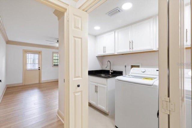 clothes washing area featuring ceiling fan, light wood-type flooring, cabinets, washer / clothes dryer, and sink