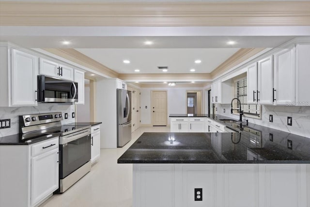 kitchen with stainless steel appliances, white cabinets, kitchen peninsula, and sink