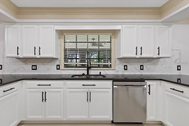 kitchen featuring backsplash, stainless steel dishwasher, sink, white cabinets, and dark stone counters