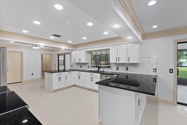 kitchen featuring white cabinets, kitchen peninsula, and plenty of natural light