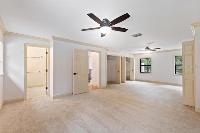 spare room with ceiling fan, light colored carpet, and crown molding