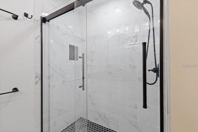 bathroom with a shower with door