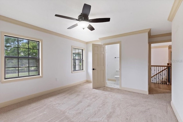 unfurnished bedroom with ensuite bathroom, ceiling fan, light carpet, and crown molding