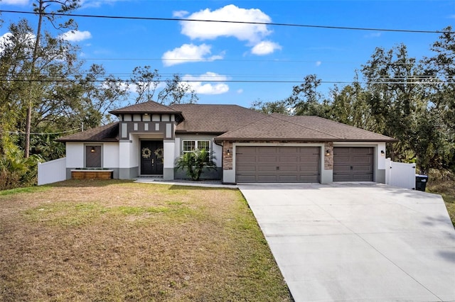 view of front of home featuring a front lawn and a garage