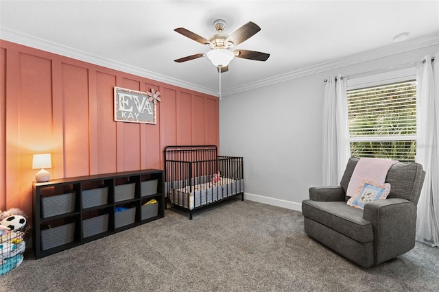 carpeted bedroom featuring ceiling fan, a crib, and ornamental molding