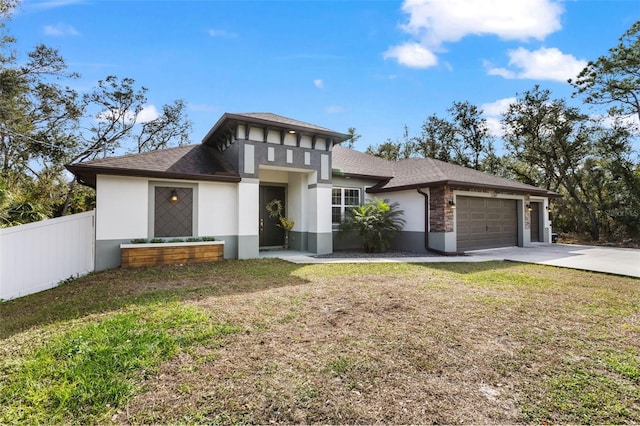 prairie-style home with a garage and a front yard