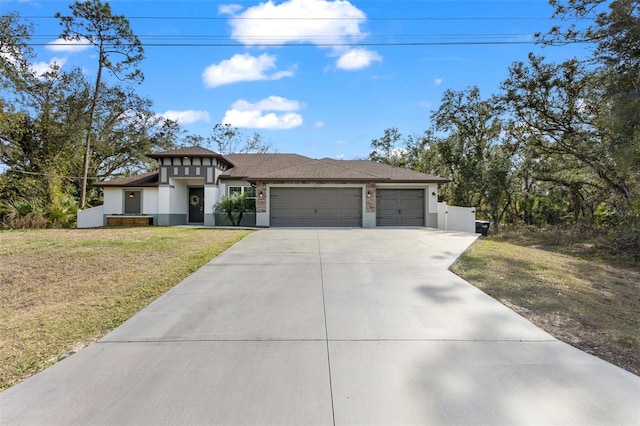 view of front of property featuring a front yard and a garage