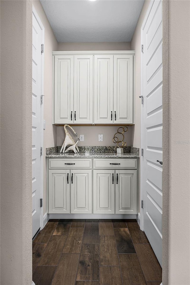 interior space featuring stone countertops and white cabinetry