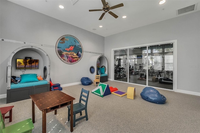 workout area featuring ceiling fan and carpet flooring