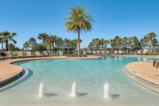 view of swimming pool featuring pool water feature and a patio