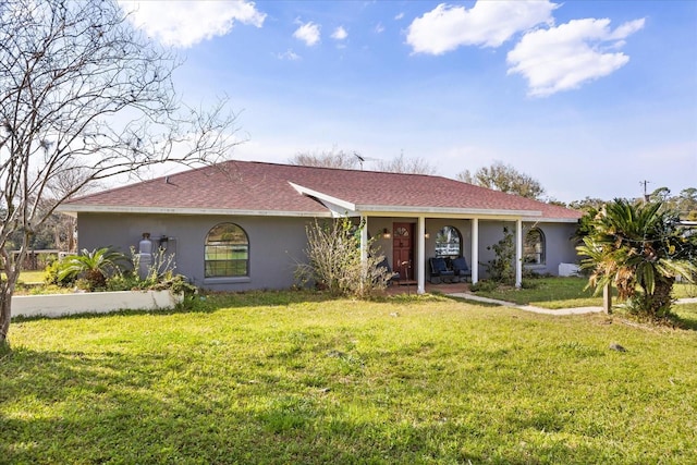 view of front of home with a front lawn and stucco siding