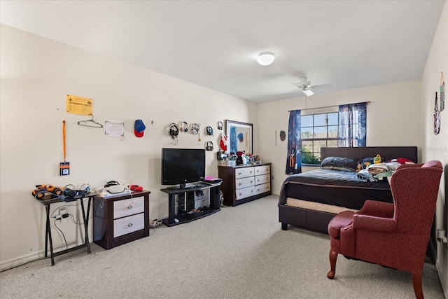 bedroom with carpet floors, a textured ceiling, baseboards, and a ceiling fan