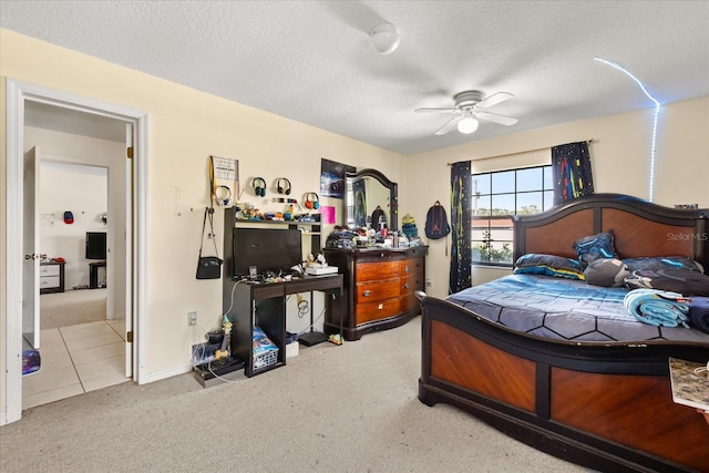 bedroom with carpet, ceiling fan, and a textured ceiling