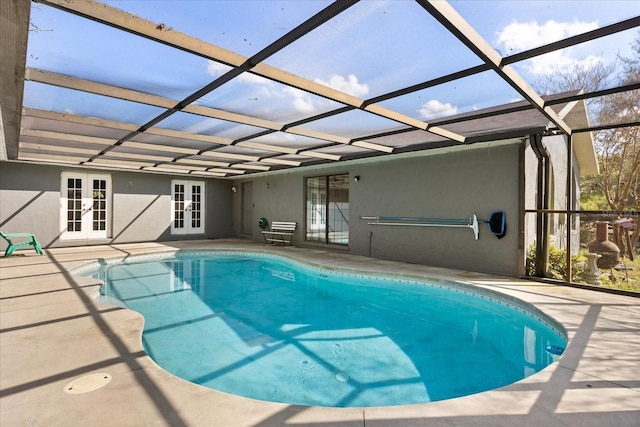 pool with french doors, a patio area, and a lanai