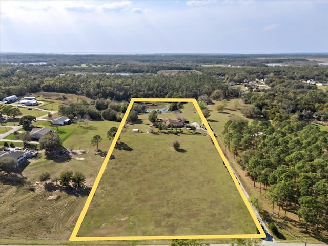 drone / aerial view with a wooded view