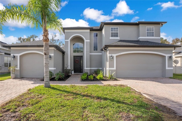 view of front of house with a garage and a front lawn