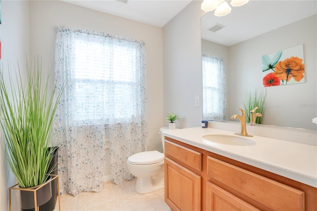 bathroom featuring tile patterned floors, toilet, and vanity