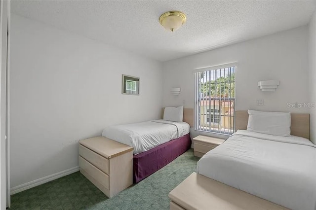 carpeted bedroom featuring a textured ceiling