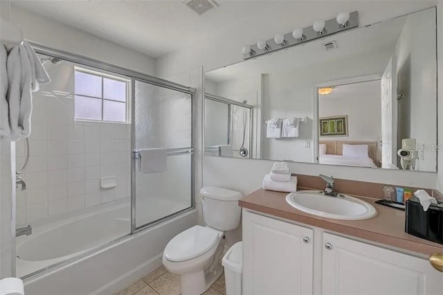 full bathroom with toilet, vanity, tile patterned flooring, and shower / bath combination with glass door