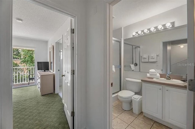 bathroom featuring vanity, toilet, a textured ceiling, and walk in shower