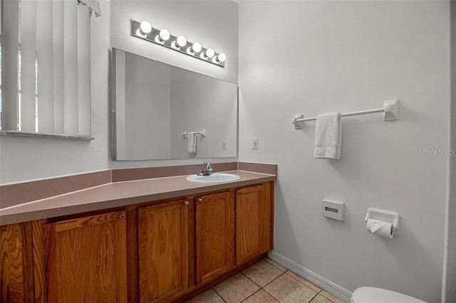 bathroom featuring toilet, tile patterned flooring, and vanity