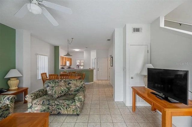 tiled living room featuring ceiling fan