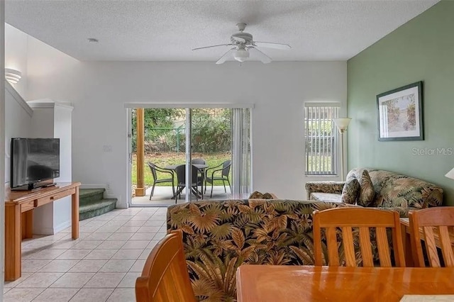 tiled living room with a textured ceiling and ceiling fan