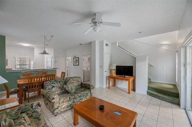 tiled living room with ceiling fan and a textured ceiling