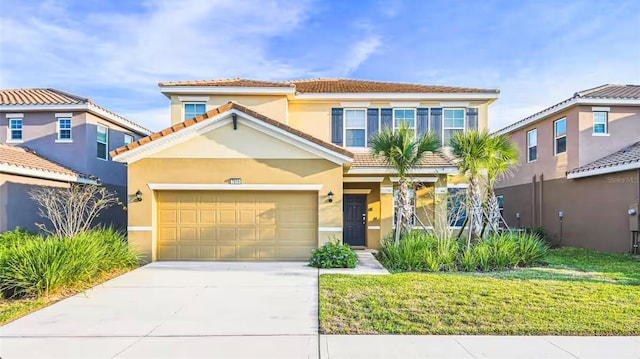 mediterranean / spanish home featuring a garage and a front yard