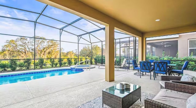 view of swimming pool with an in ground hot tub, glass enclosure, and a patio