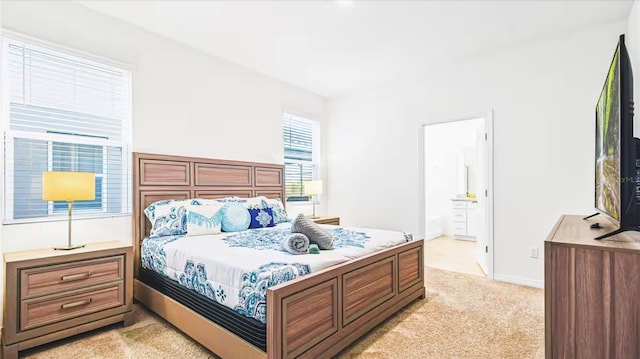 carpeted bedroom with ensuite bath