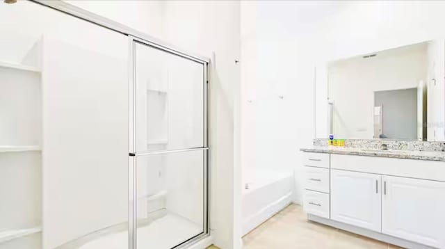 bathroom with vanity and plus walk in shower