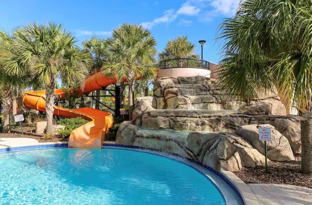 view of swimming pool featuring pool water feature