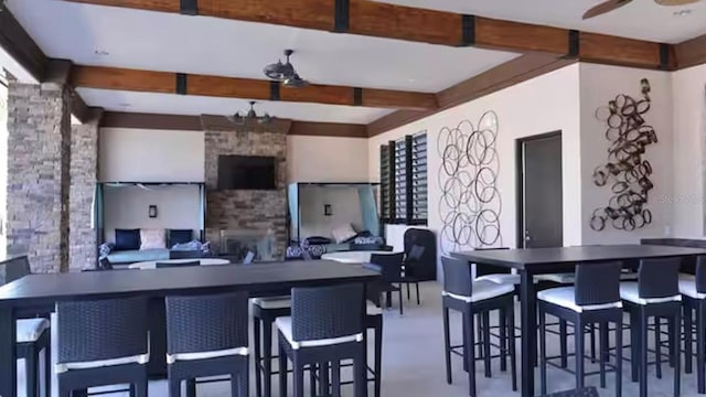 kitchen featuring beam ceiling and ceiling fan